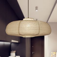 a lamp hanging from the ceiling in a kitchen