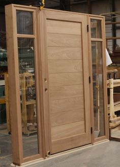 a large wooden door sitting inside of a building