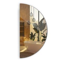 a bathroom with a large round mirror on the wall and a plant in the bathtub