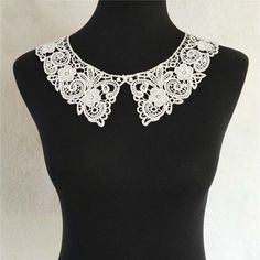 a white lace necklace on a mannequin neckline with flowers in the center