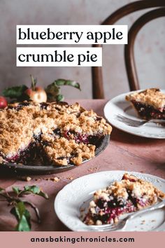 blueberry apple crumble pie on a table with two plates and one slice missing