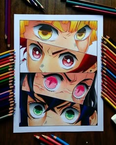 some colored pencils are next to a drawing of two anime characters with big eyes