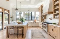 a large kitchen with wooden cabinets and white counter tops, along with an area rug on the floor