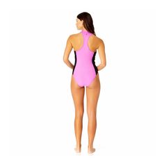 a woman in a pink and black one piece swimsuit with her back to the camera