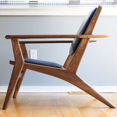 a wooden chair sitting on top of a hard wood floor