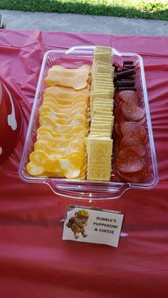 a table topped with lots of different types of food on top of a red cloth