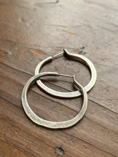 These hoops are PERFECTLY rustic like a set of modern day artifacts.  They compliment an style, be it BOHO, minimalist or professional.  These aren't commonplace prefab hoops because each one is crafted by hand with love but they WILL  be your new favorite for everyday wear! MORE SIZES AVAILABLE HERE:https://www.etsy.com/listing/772693798/large-sterling-silver-hoop-earrings-in?ref=shop_home_active_1&pro=1&frs=1All jewelry from my studio is endowed with a lifetime craftsmanship guarantee Adjustable Soldered Hoop Earrings For Gifts, Modern Hand Forged Circle Hoop Earrings, Hammered Adjustable Small Hoop Earrings, Small Hammered Adjustable Hoop Earrings, Gift Hoop Earrings With Soldered Metal, Artisan Small Hoop Metal Earrings, Handmade Round Hoop Earrings For Everyday, Handmade Hoop Earrings For Everyday, Modern Handmade Small Hoop Jewelry