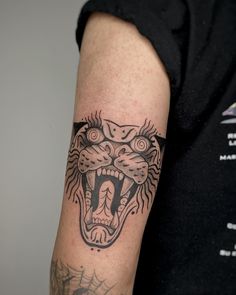 a man with a tattoo on his arm has a black and white tiger design on it