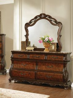 an ornate dresser and mirror in a room