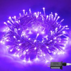 purple led christmas lights with white stars on the top and one wire is plugged in