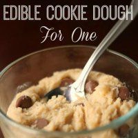 a close up of a spoon in a bowl of food with the words edible cookie dough for one