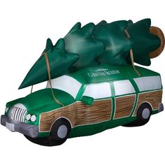 an inflatable car with a christmas tree on the roof and bows attached to it