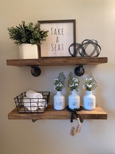 Floating shelves, vase, plant, beads, sign, Shelving Ideas Bathroom, Oasis Home Decor, Home Ideas Bathroom, Bathroom Shelf Decor Ideas, Farmhouse Rustic Bathroom, Bathroom Shelving Ideas, Oasis Home, Shelves Over Toilet, Toilet Room Decor