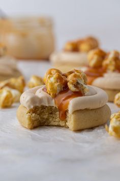 some cookies with caramel toppings on top of each one and others in the background