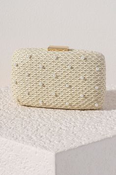 Add a touch of elegance to your summer accessories with Shiraleah's Lola Minaudiere. With a simple netted ivory background, the faux pearl details are the star of the show on this purse. You can carry it as a clutch, or use the detachable cross-body chain to add some versatility to your style. Pair with other items from Shiraleah to complete your look! Features A Detachable Cross-Body Chain And Pick-Lock Closure Shiraleah Is A Trend-Driven Lifestyle Brand Focused On The Little Gifts That Make Life Special! Made From Polypropylene And Faux Pearls, With Gold Hardware Measures L 7" X W 2" X H 4.25"; Chain 23" Made In China Elegant Summer Clutch, Feminine Beige Evening Bag, Beige Feminine Evening Bag, Elegant Summer Evening Bag, Feminine Beige Clutch For Evening, Party Clutch With Pearl Handle In Beige, Beige Clutch With Pearl Handle For Party, Elegant Summer Clutch Bag, Chic Beige Evening Clutch