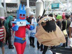 people in costumes are walking through an airport