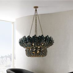 a chandelier hanging from the ceiling in a room with white walls and flooring