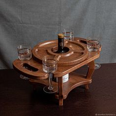 a wooden tray with wine glasses and a bottle on it