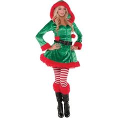 a woman in a green and red christmas costume standing with her hands on her hips