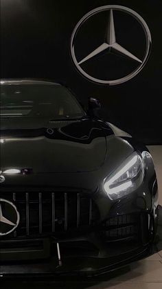 the front end of a black mercedes sports car