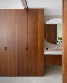 a bathroom with wooden cabinets and a mirror