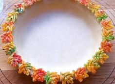 a plate that has some kind of colorful decoration on it's rim and is sitting on a table