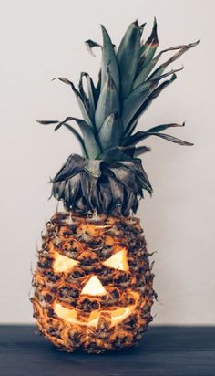 a pineapple with a carved jack o lantern on it