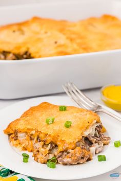 a white plate topped with lasagna next to a casserole dish