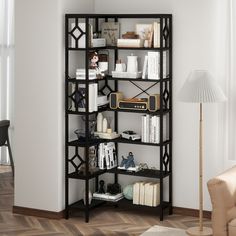 a book shelf with many books on it in a living room next to a lamp