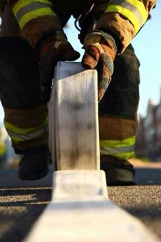 a fireman is working on the side of a building