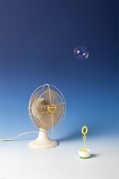 a small fan sitting on top of a white table