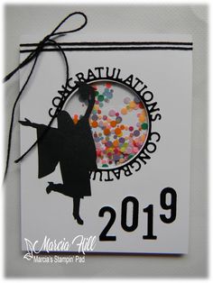 a white card with a black silhouette of a person holding a hat and balloons in the air