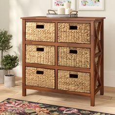 a wooden cabinet with baskets on top of it and a rug in front of it