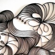 an abstract paper art piece with black and white lines on the bottom half of it