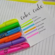 several pens are lined up next to each other on top of a notepad that says color code