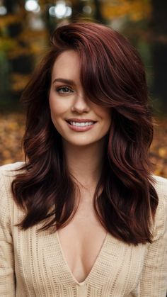 Deep Auburn Waves with Face-Framing Layers bring a touch of sophistication and elegance to your fall look. The deep auburn shade is rich and luxurious, while the waves add a soft, romantic feel. Face-framing layers highlight your facial features, making this hairstyle suitable for all face shapes, especially for those who want to add some dimension to their hair. Med Red Hair, Red Over Brown Hair No Bleach, Fall Hair Color For Brunettes Red Copper, Auburn Hair For Fair Skin, Dokata Johnson Hair, Dark Auburn Hair With Bangs, Auburn Hair Color Pale Skin, Level 4 Red Hair, Auburn Layered Hair