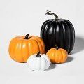 three black and white pumpkins sitting next to each other