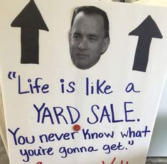 a yard sale sign with an image of a man's face and two arrows