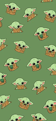 the baby yoda is eating something with it's hands and eyes, as if he