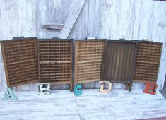 three wooden bookshelves sitting next to each other in front of a barn door