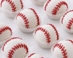 white chocolates with red stitching on them are arranged in a row and lined up