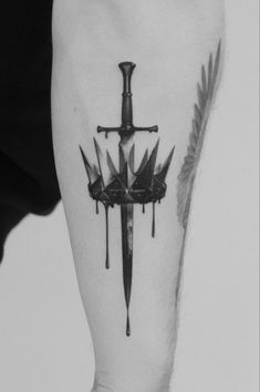 a black and white photo of a cross with two swords on it's leg