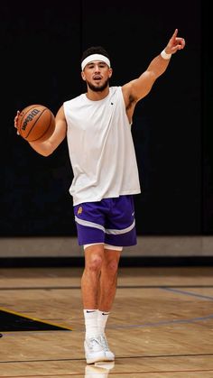 a man holding a basketball in his right hand