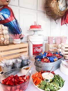 a table topped with lots of food and balloons