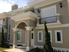 a large house with two balconies on the second floor and an attached balcony