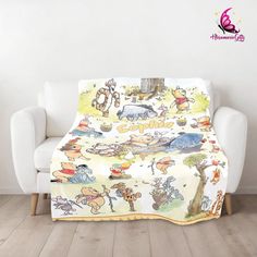 winnie the pooh blanket on a couch in front of a white chair and wall