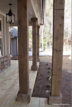 the porch is covered in wood and has columns