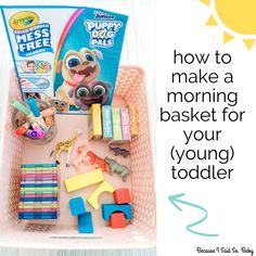 a plastic tray filled with toys on top of a wooden table next to a sign that says how to make a morning basket for your young toddler