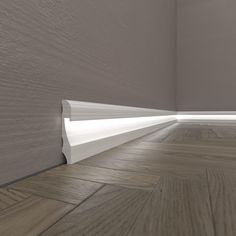 an empty room with wood flooring and white trimmings on the walls is shown in this image