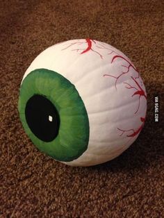 an eyeball on the ground with blood all over it